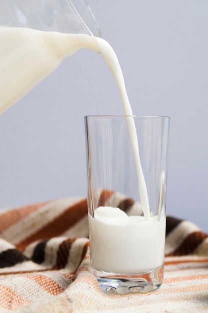 Free photo pouring milk inside the glass