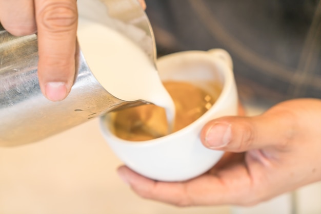 Pouring milk to mix Latte Coffee art