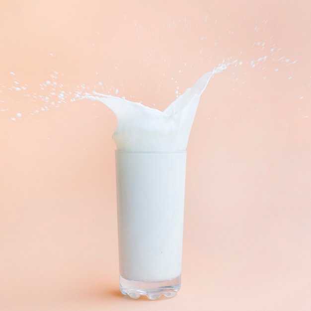 Free photo pouring milk out of glass