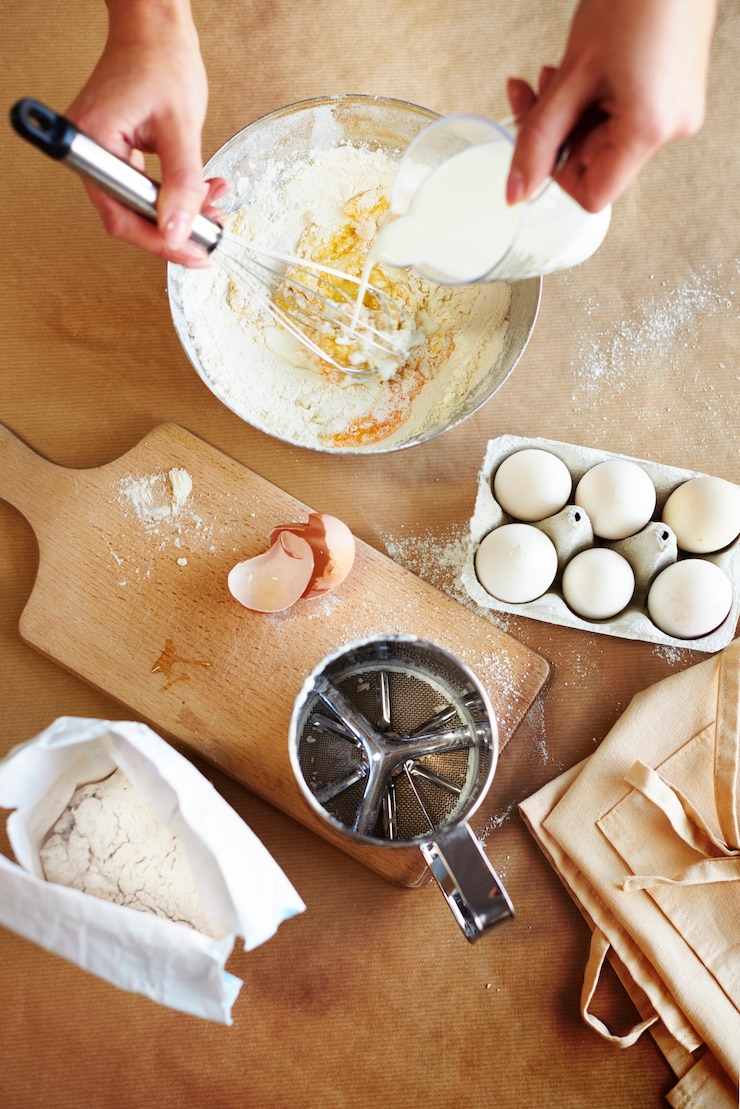 Free Photo pouring milk and using a whisk
