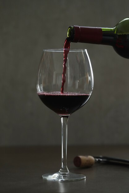 Pouring red wine in glass