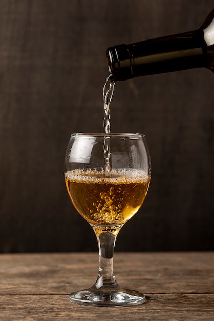 Pouring white wine in glass