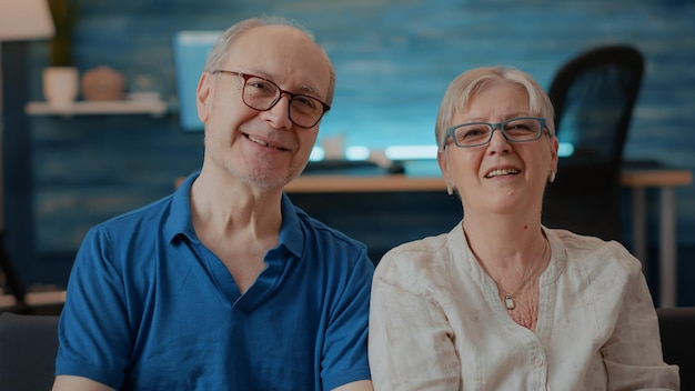 Free photo pov of retired husband and wife talking to people on video call connection. senior couple waving at online meeting webcam, using remote videoconference for telecommunication on internet.