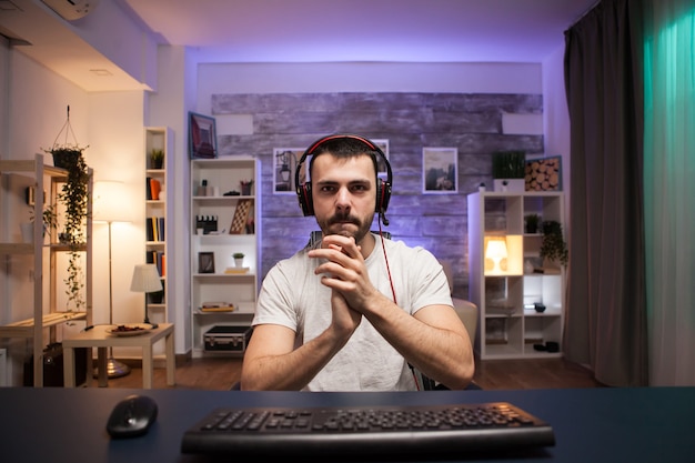 Free photo pov of young man clapping after his victory while playing online shooter games.