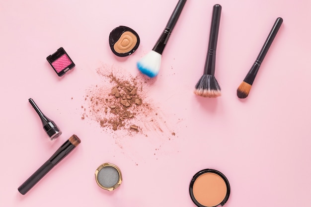 Powder brushes with crushed facial powder on table