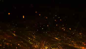 Бесплатное фото Частицы порошковой пыли на фоне золотого блеска