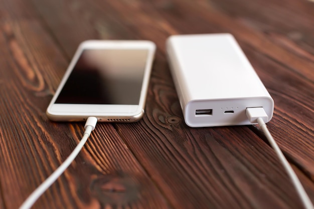 Powerbank and cellphone on wooden table