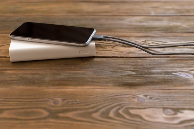 Powerbank and cellphone on wooden table