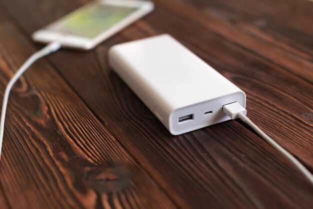 Powerbank and cellphone on wooden table