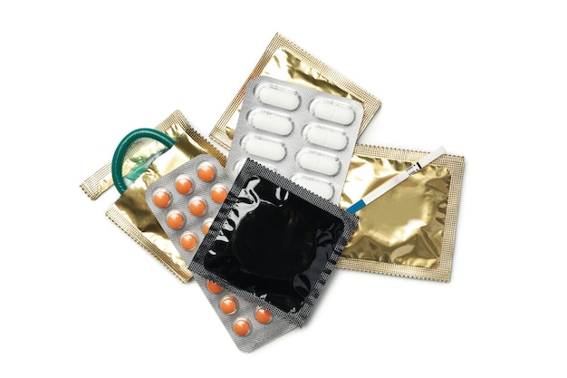 Pregnancy test, condoms and pills isolated on white surface