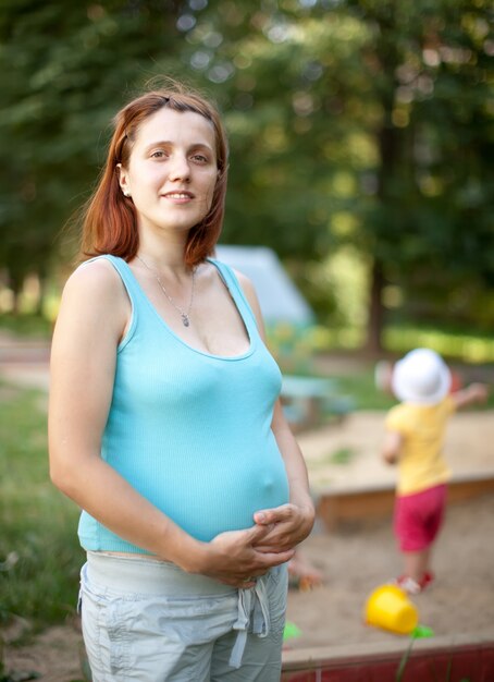 pregnancy woman against  playground area