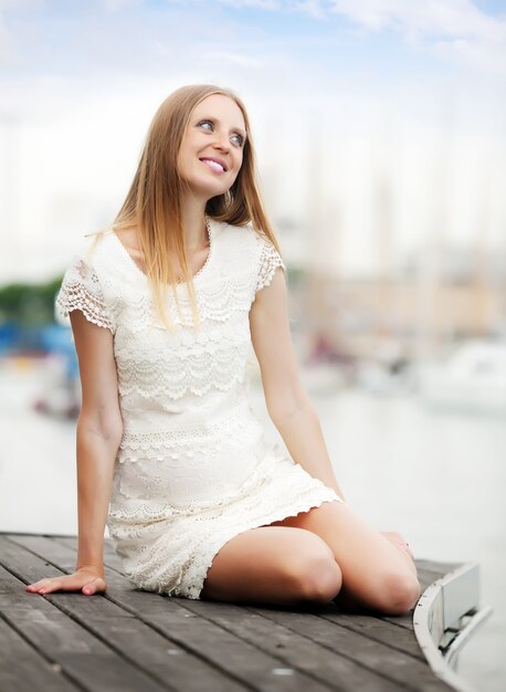 pregnancy woman sitting at port