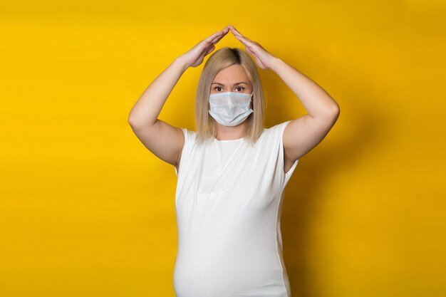 Download Premium Photo Coronavirus Pandemic Young Pregnant Woman On Yellow Background In Protective Medical Mask And Spray Antiseptic In Hand PSD Mockup Templates