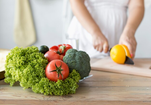 pregnant woman cutting an orange