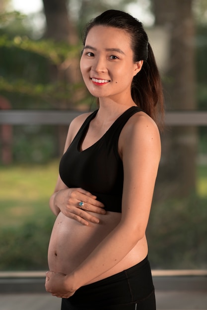 Pregnant woman dressed in sports attire