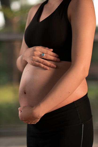 Pregnant woman dressed in sports attire