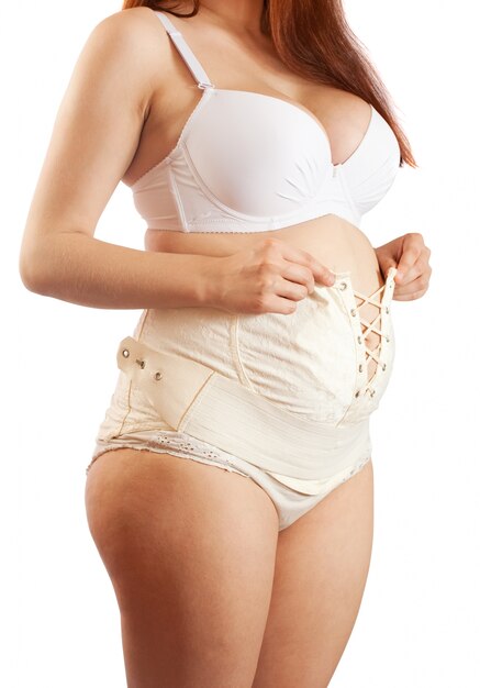 pregnant woman dressing maternity girdle