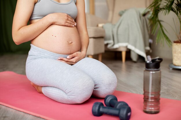 Pregnant woman exercising at home