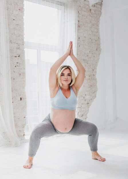 Pregnant woman exercising indoors