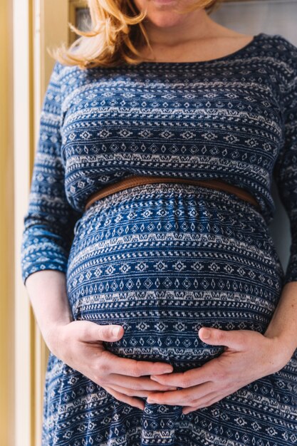 Pregnant woman in front of balcony