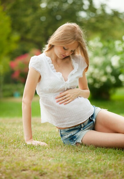 Pregnant woman on grass