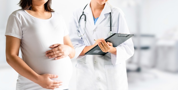 Pregnant woman and gynecologist doctor at hospital