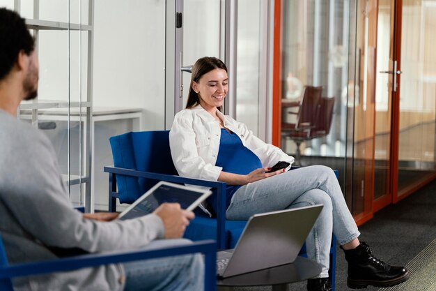 Pregnant woman having a meeting with her coworker