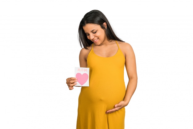 Pregnant woman holding greeting card.