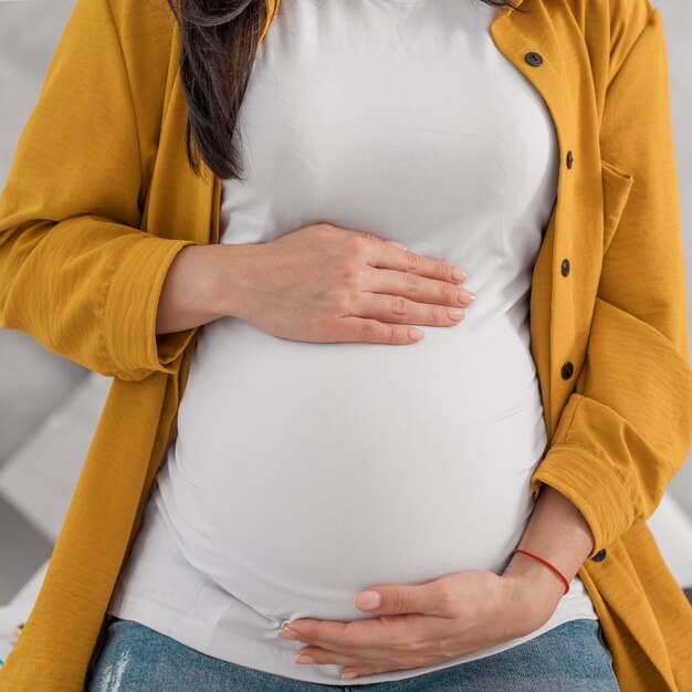 Pregnant woman holding her belly