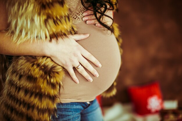 Pregnant woman holding her hand on the belly