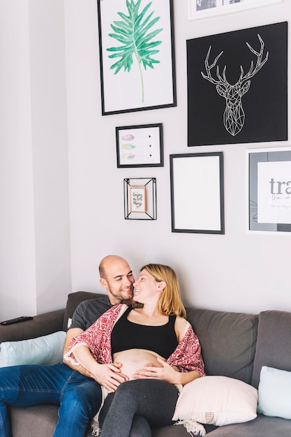 Pregnant woman and husband on couch