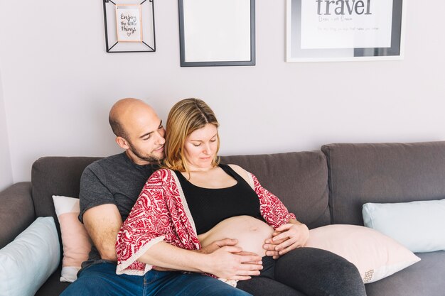 Pregnant woman and husband in living room