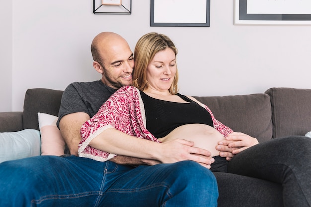 Pregnant woman and husband in living room