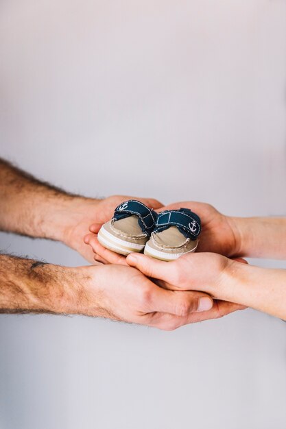 Donna incinta e marito con scarpe da bambino