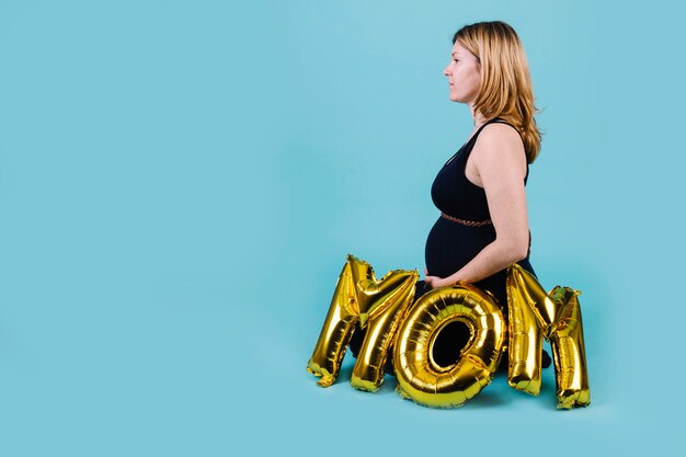 Pregnant woman and letters