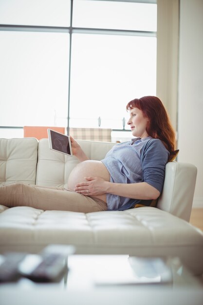 Pregnant woman looking at a sonography on digital table