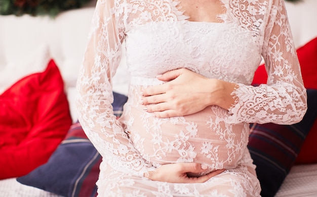 Pregnant woman portrait, New Year vibes. Charming blonde expecting woman