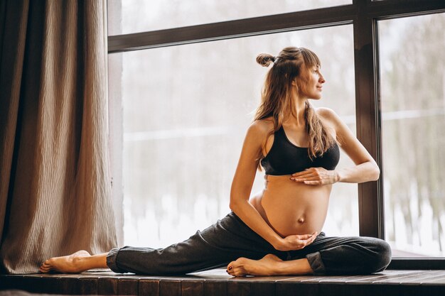 Беременная женщина практикующих йогу