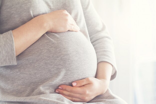 Pregnant woman touching her belly