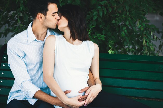 Pregnant woman touching her husband hands