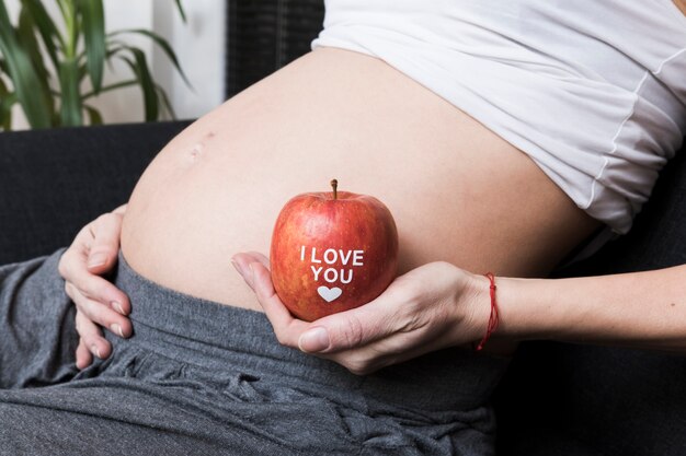 Pregnant woman with apple