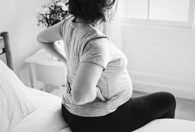 Free photo pregnant woman with back pain