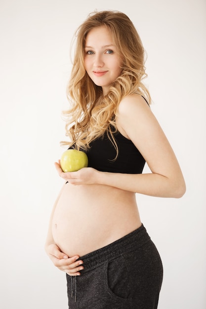 pregnant woman with blond hair in comfy black clothes smiling