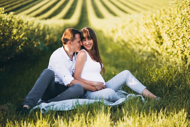 Pregnant woman with her husband in park