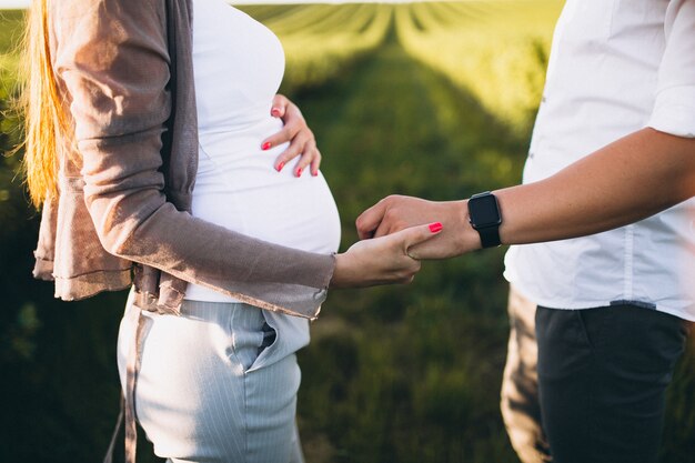 Pregnant woman with her husband in park