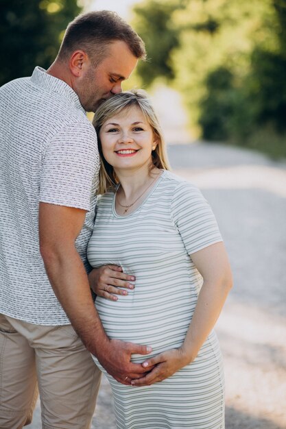 Pregnant woman with her husband in park