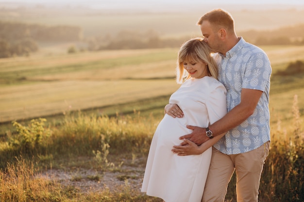 Pregnant woman with her husband in park