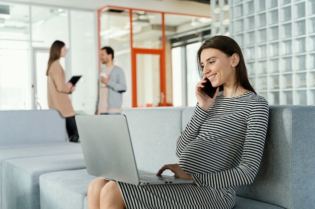 Foto gratuita donna incinta che lavora in ufficio