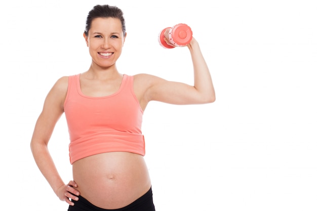 Pregnant woman working out with dumbbells