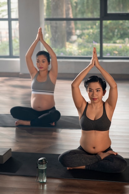 Pregnant women practicing yoga together